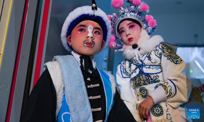 Zhang Zixuan (L) and Xie Suqian, pupils of the little Kunqu Opera training class of Shipai Center Primary School, wait for a Kunqu Opera performance in Kunshan City, east China's Jiangsu Province, May 31, 2024. (Photo: Xinhua)