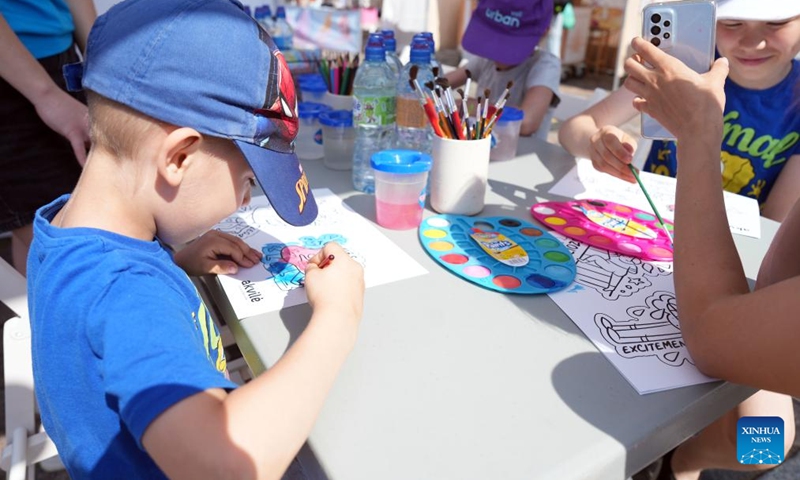 Children paint during an event to mark the International Children's Day at the Dome Square in Riga, Latvia, June 1, 2024. The International Children's Day was celebrated in Riga on Saturday. (Photo: Xinhua)