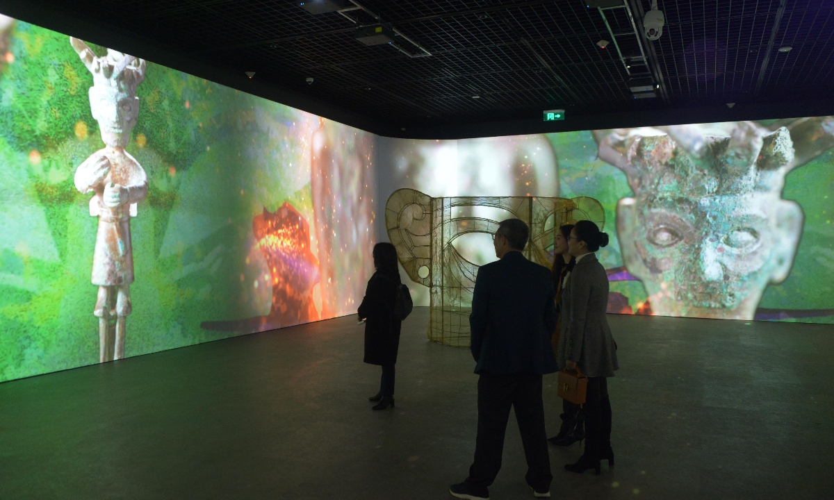 Visitors explore a digital exhibition on Sanxingdui cultural relics in Shanghai. Photo: VCG