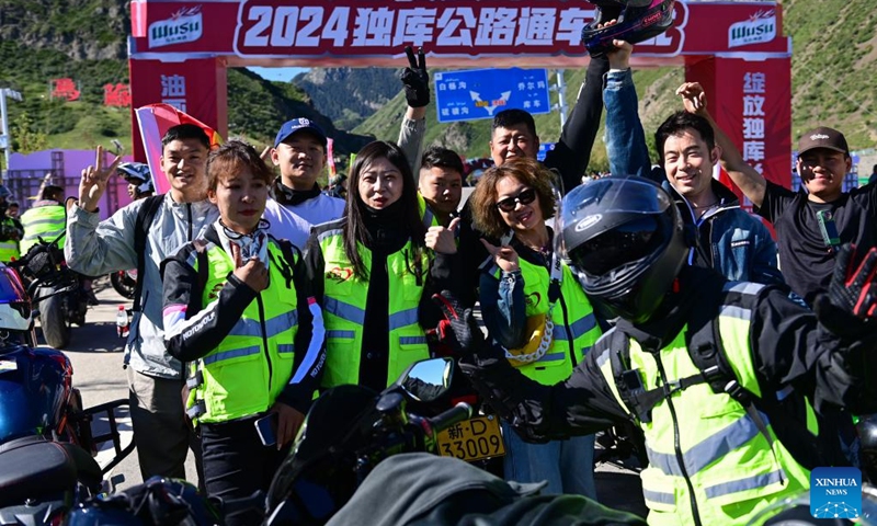 Motorcyclists pose for a group photo at a service area along the Duku Highway in Usu City, northwest China's Xinjiang Uygur Autonomous Region, June 1, 2024. (Photo: Xinhua)