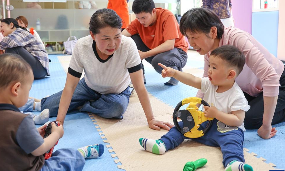 Children exchange their toys during an activity at a Community Based Family Support (CBFS) center at the Jinxiu community of Xiling District, Yichang City of central China's Hubei Province, April 24, 2024. (Photo: Xinhua)