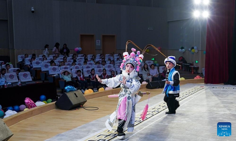 Zhang Zixuan (behind) and Xie Suqian, pupils of the little Kunqu Opera training class of Shipai Center Primary School, perform Kunqu Opera in Kunshan City, east China's Jiangsu Province, May 31, 2024. (Photo: Xinhua)