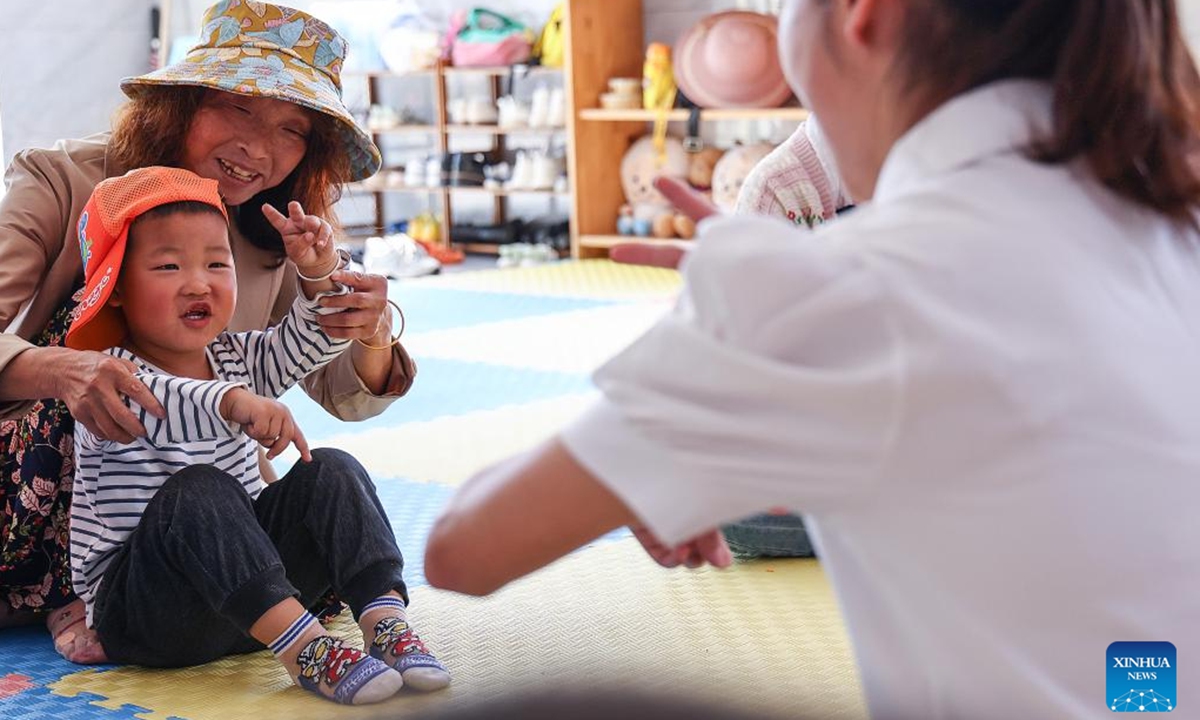 A boy takes part in a reading activity at a Community Based Family Support (CBFS) center in Aijia Village, Yichang City of central China's Hubei Province, April 23, 2024. (Photo: Xinhua)