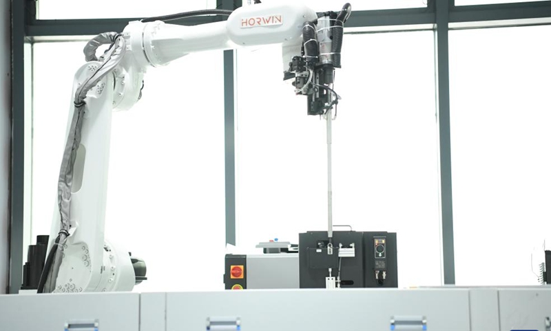 This photo taken on June 1, 2024 shows an automated robot arm working at a workshop of Horwin in Changzhou, east China's Jiangsu Province. Founded in 2016, Horwin is a pioneering manufacturer of intelligent electric motorcycles, primarily targeting the overseas market. Boasting over 200 core technology patents, Horwin's electric motorcycles are sold in more than 100 countries and regions. (Photo: Xinhua)