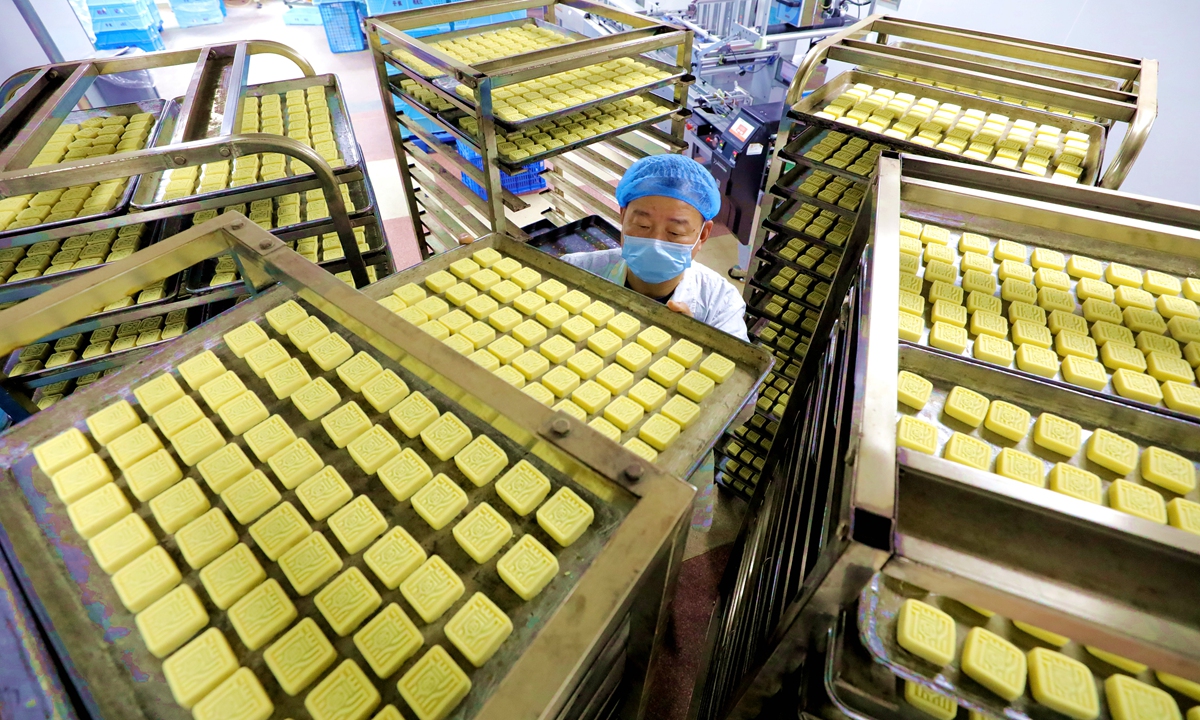 A worker produces mung bean cakes at a food production enterprise in Anqing, East China's Anhui Province on June 3, 2024. As the Dragon Boat Festival approaches, a number of food production enterprises have increased efforts to make all kinds of traditional pastries in order to supply the holiday market. Photo: cnsphoto