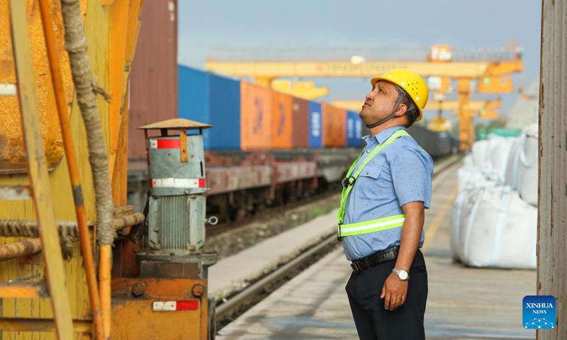 This photo taken on May 14, 2023 shows Hamit Turgun checking the crane operation conditions at the Horgos railway port in Horgos, northwest China's Xinjiang Uygur Autonomous Region. (Photo: Xinhua)