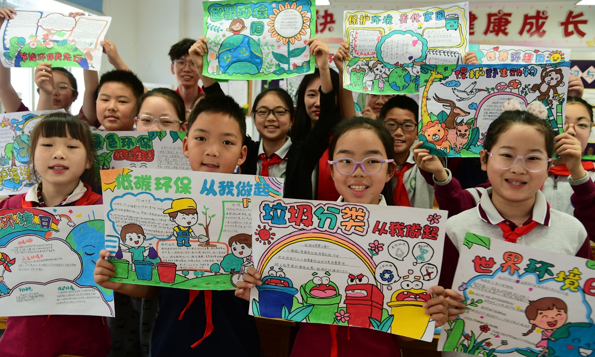 Students display their hand-written newspapers on the theme of Environmental Day in a school in Zhenjiang, East China's Jiangsu Province on June 3, 2024.