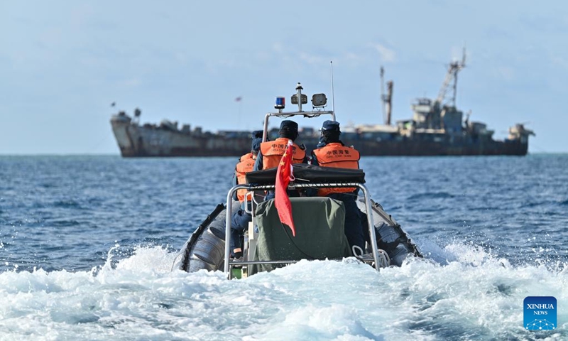 Law enforcers of China Coast Guard inspect near an illegally grounded Philippine navy transport ship on May 16, 2024. Recently, in China's Ren'ai Jiao and the surrounding territorial sea, personnel from the illegally grounded Philippine navy transport ship Sierra Madre repeatedly damaged Chinese fishermen's nets.(Photo: Xinhua)