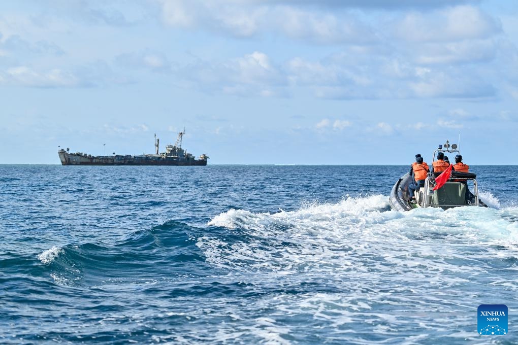 Law enforcers of China Coast Guard inspect near an illegally grounded Philippine navy transport ship on May 16, 2024. Recently, in China's Ren'ai Jiao and the surrounding territorial sea, personnel from the illegally grounded Philippine navy transport ship Sierra Madre repeatedly damaged Chinese fishermen's nets.(Photo: Xinhua)