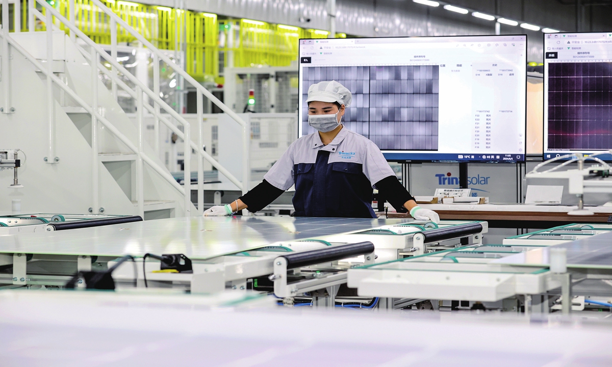 A worker catches up on export orders for photovoltaic products at a workshop in Suqian, East China's Jiangsu Province on June 5, 2024. Suqian has been boosting the construction of new-energy projects in a bid to promote the upgrading and transformation of the local manufacturing sector. Photo: cnsphoto