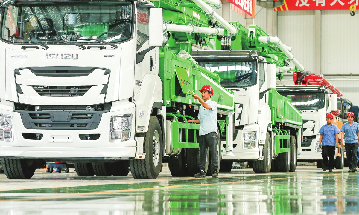 An employee inspects concrete pump trucks to be exported to overseas markets from a factory in Qingdao, East China's Shandong Province on June 6, 2024. Data from China Association of Automobile Manufacturers showed that China exported 1.32 million cars in the first three months of this year, up 33.2 percent than the same period of last year. Photo: VCG