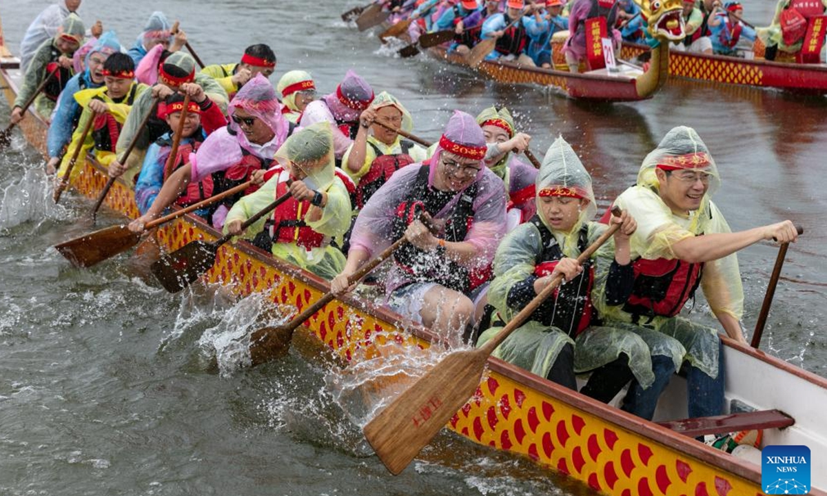 Teams compete during a dragon boat race in Lixianghu Township of southwest China's Chongqing Municipality, June 8, 2024. To celebrate the upcoming Duanwu, or the Dragon Boat Festival, dragon boat races were held in many places in China. The festival is celebrated on the fifth day of the fifth month on the Chinese lunar calendar to commemorate ancient Chinese poet Qu Yuan from the Warring States Period (475-221 B.C.). (Photo by Luo Chuan/Xinhua)

