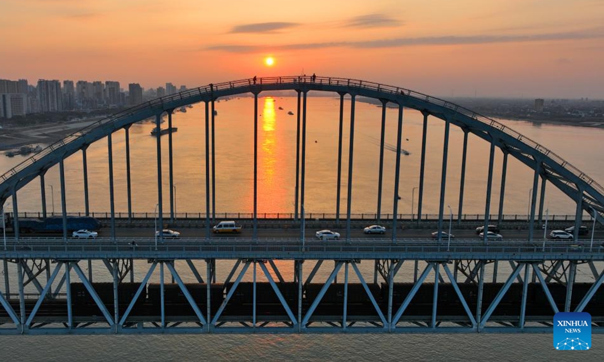 A drone photo taken on April 26, 2023 shows a section of the Yangtze River at sunset in Ruichang of Jiujiang, east China's Jiangxi Province. In recent years, provinces in China's central region have been striving to construct modernized transportation system based on geographical advantage, industrial foundation and resource endowment. (Xinhua/Zhou Mi)

