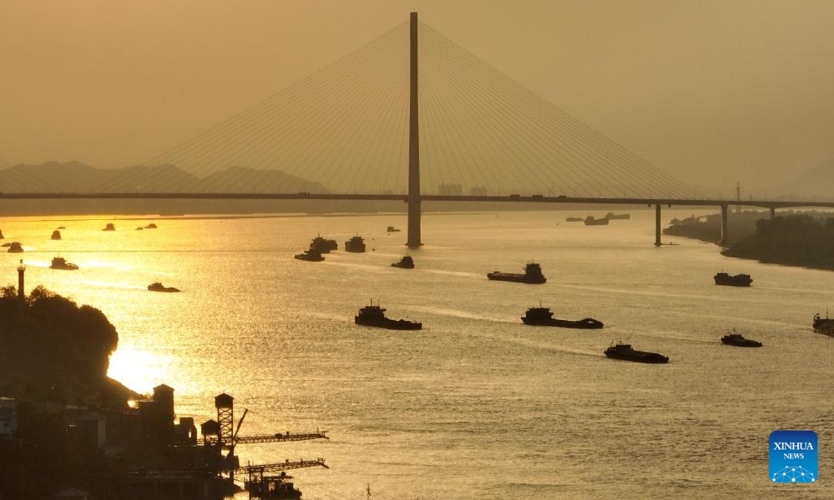 A drone photo taken on April 26, 2023 shows a section of the Yangtze River at sunset in Ruichang of Jiujiang, east China's Jiangxi Province. In recent years, provinces in China's central region have been striving to construct modernized transportation system based on geographical advantage, industrial foundation and resource endowment. (Xinhua/Zhou Mi)

