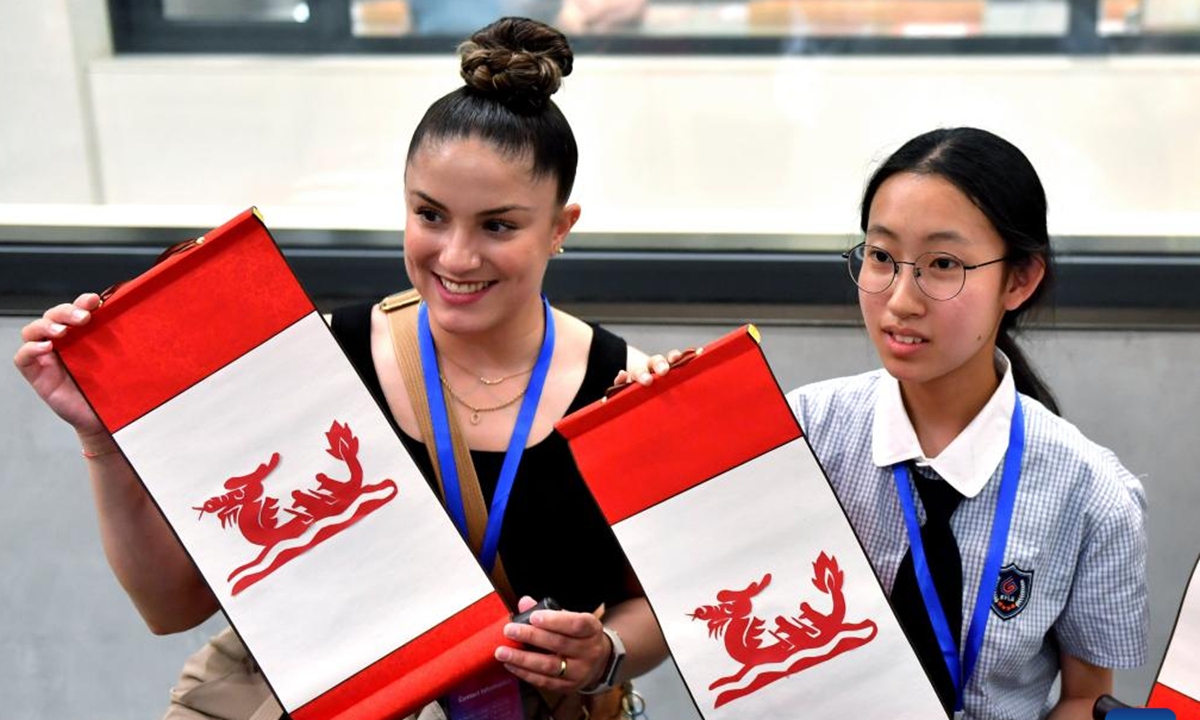Chinese and American students show their paper cut works featuring the dragon boat during a cultural event at Shijiazhuang Foreign Language School in Shijiazhuang, north China's Hebei Province, June 8, 2024. A delegation of 51 students and teachers from U.S. state Iowa took part in a cultural event to greet the Duanwu Festival, or the Dragon Boat Festival, in Shijiangzhuang on Saturday. (Xinhua/Wang Xiao)


