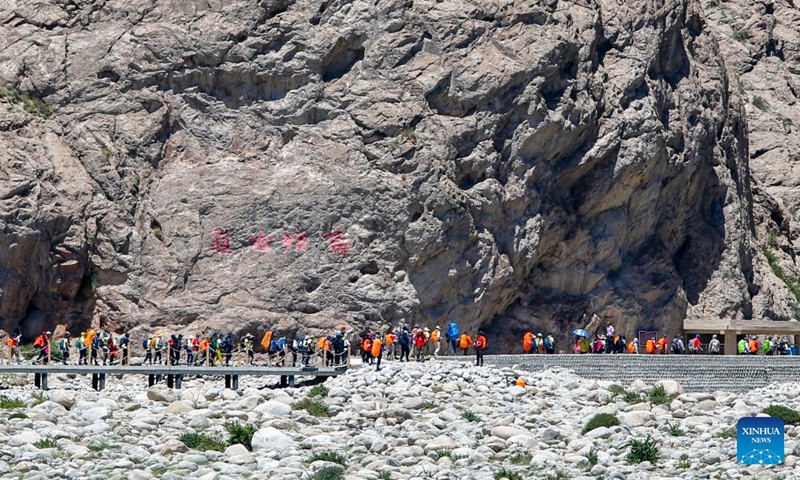 Hiking enthusiasts go for a hike on the Wusun ancient road in Baicheng County, northwest China's Xinjiang Uygur Autonomous Region, June 9, 2024. A 7-day event featuring hiking and camping was launched here on Sunday, attracting more than 150 hiking enthusiasts from all over the country. (Photo: Xinhua)