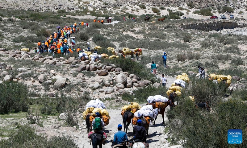 Hiking enthusiasts go for a hike on the Wusun ancient road in Baicheng County, northwest China's Xinjiang Uygur Autonomous Region, June 9, 2024. A 7-day event featuring hiking and camping was launched here on Sunday, attracting more than 150 hiking enthusiasts from all over the country. (Photo: Xinhua)