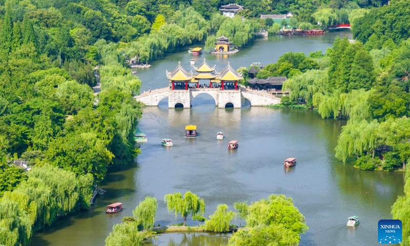 An aerial drone photo shows tourists visiting the Slender West Lake scenic spot in Yangzhou, east China's Jiangsu Province, June 10, 2024. China saw 110 million domestic tourist trips made during the three-day Dragon Boat Festival holiday, up 6.3 percent from the same period last year, the Ministry of Culture and Tourism said Monday. (Photo: Xinhua)