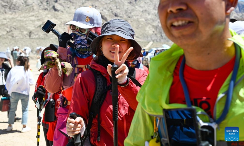 Hiking enthusiasts go for a hike on the Wusun ancient road in Baicheng County, northwest China's Xinjiang Uygur Autonomous Region, June 9, 2024. A 7-day event featuring hiking and camping was launched here on Sunday, attracting more than 150 hiking enthusiasts from all over the country. (Photo: Xinhua)