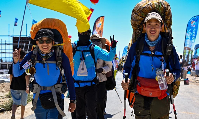 Hiking enthusiasts go for a hike on the Wusun ancient road in Baicheng County, northwest China's Xinjiang Uygur Autonomous Region, June 9, 2024. A 7-day event featuring hiking and camping was launched here on Sunday, attracting more than 150 hiking enthusiasts from all over the country. (Photo: Xinhua)