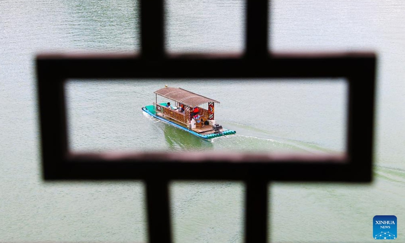 Tourists on a bamboo raft visit Zhuoshui ancient town in Qianjiang District of southwest China's Chongqing, June 10, 2024. China saw 110 million domestic tourist trips made during the three-day Dragon Boat Festival holiday, up 6.3 percent from the same period last year, the Ministry of Culture and Tourism said Monday. (Photo: Xinhua)