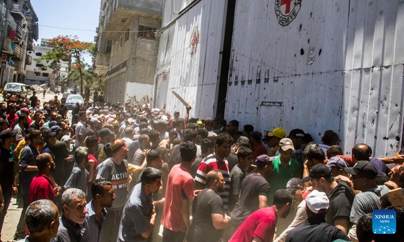 Palestinians gather to receive food aid in the Sheikh Radwan area in northern Gaza City, on June 11, 2024. (Photo: Xinhua)