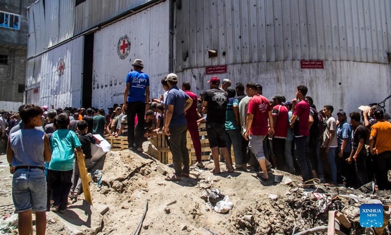 Palestinians gather to receive food aid in the Sheikh Radwan area in northern Gaza City, on June 11, 2024. (Photo: Xinhua)