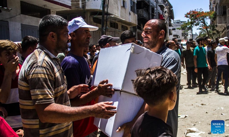 Palestinians gather to receive food aid in the Sheikh Radwan area in northern Gaza City, on June 11, 2024. (Photo: Xinhua)