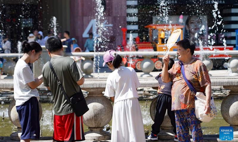 People cool themselves near a fountain in Beijing, capital of China, June 9, 2024. (Photo: Xinhua)