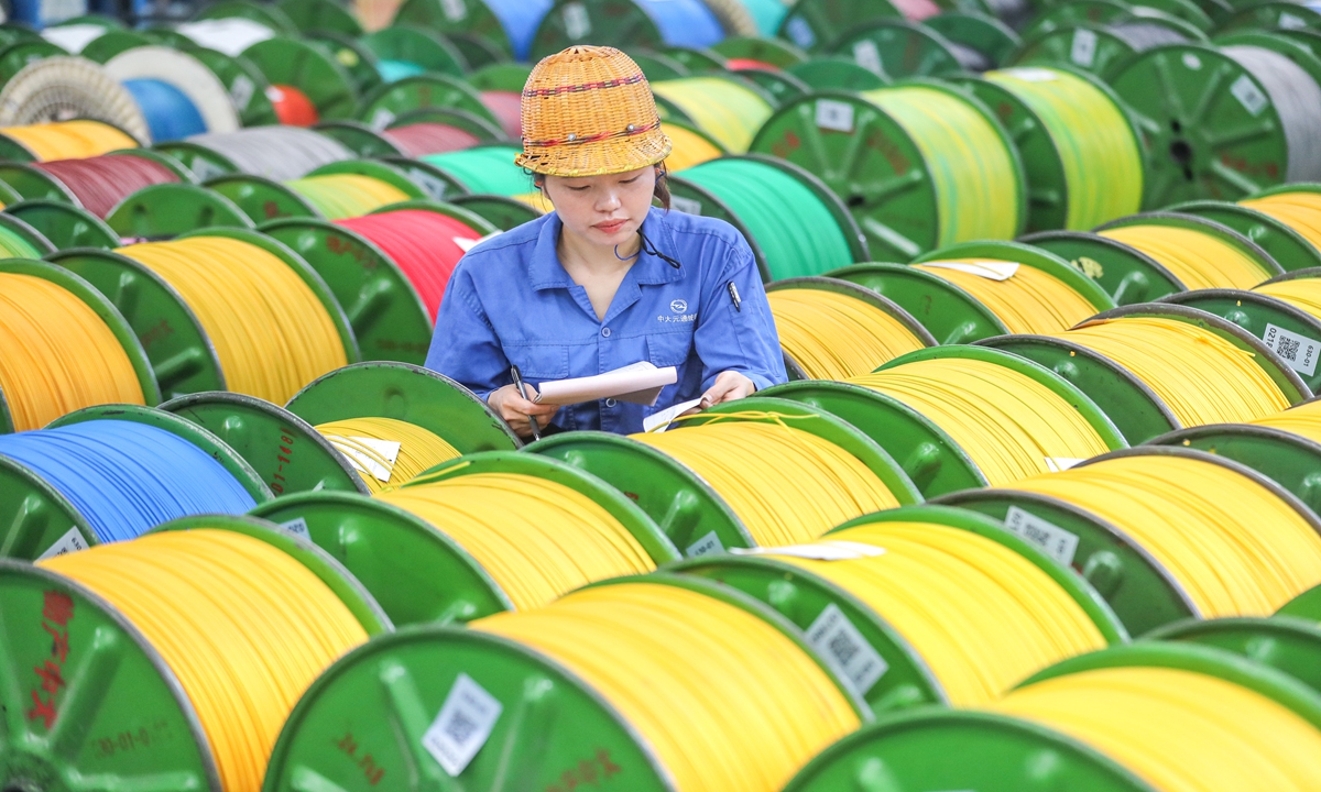 A worker checks a batch of special cable products at a smart industrial park in Deqing county, East China's Zhejiang Province on June 12, 2024. The company is among a new batch of enterprises that have the status of 