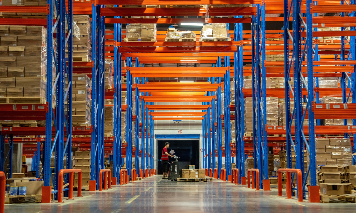 A worker handles packages at a warehouse in Jinhua, East China's Zhejiang Province on June 13, 2024 ahead of the upcoming 