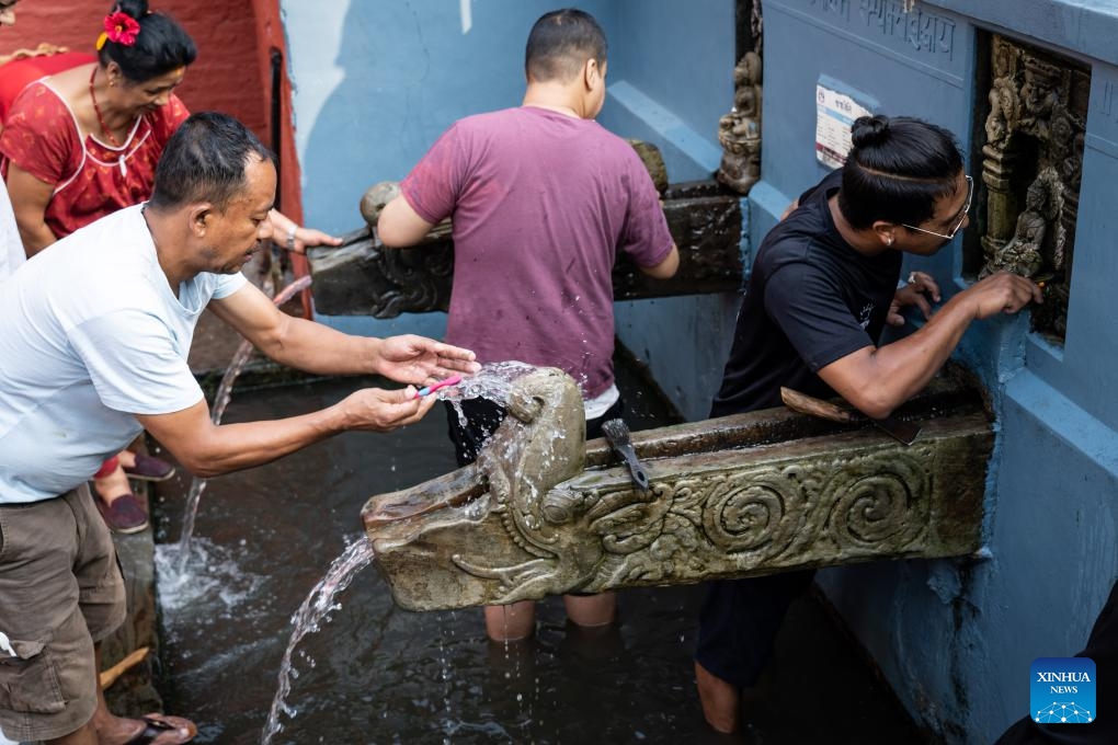People clean stone waterspouts on the occasion of the Sithi Nakha Festival in Lalitpur, Nepal, June 12, 2024. The Newar community celebrates the Sithi Nakha festival to mark the beginning of monsoon season by cleaning water sources such as ponds, wells and stone spouts. People also prepare traditional pancakes such as Bara and Chatamari as a tribute to their ancestral god.(Photo: Xinhua)