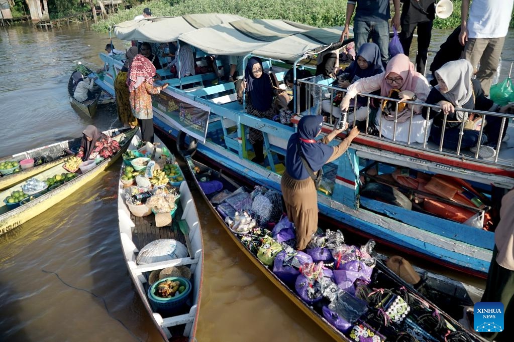 Vendors riding in klotok boats offer products to costumers at a floating market of Lok Baintan village in Banjar regency, South Kalimantan, Indonesia, June 12, 2024.(Photo: Xinhua)