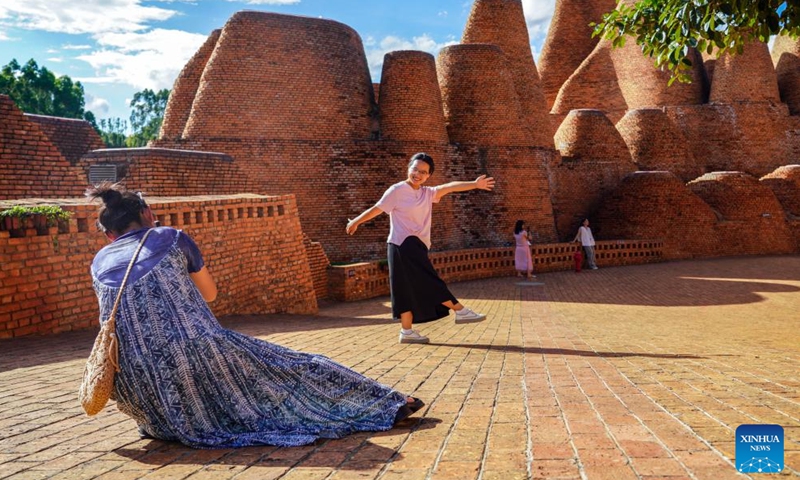 Tourists take photos at Dongfengyun town in Mile, southwest China's Yunnan Province, on June 13, 2024. 