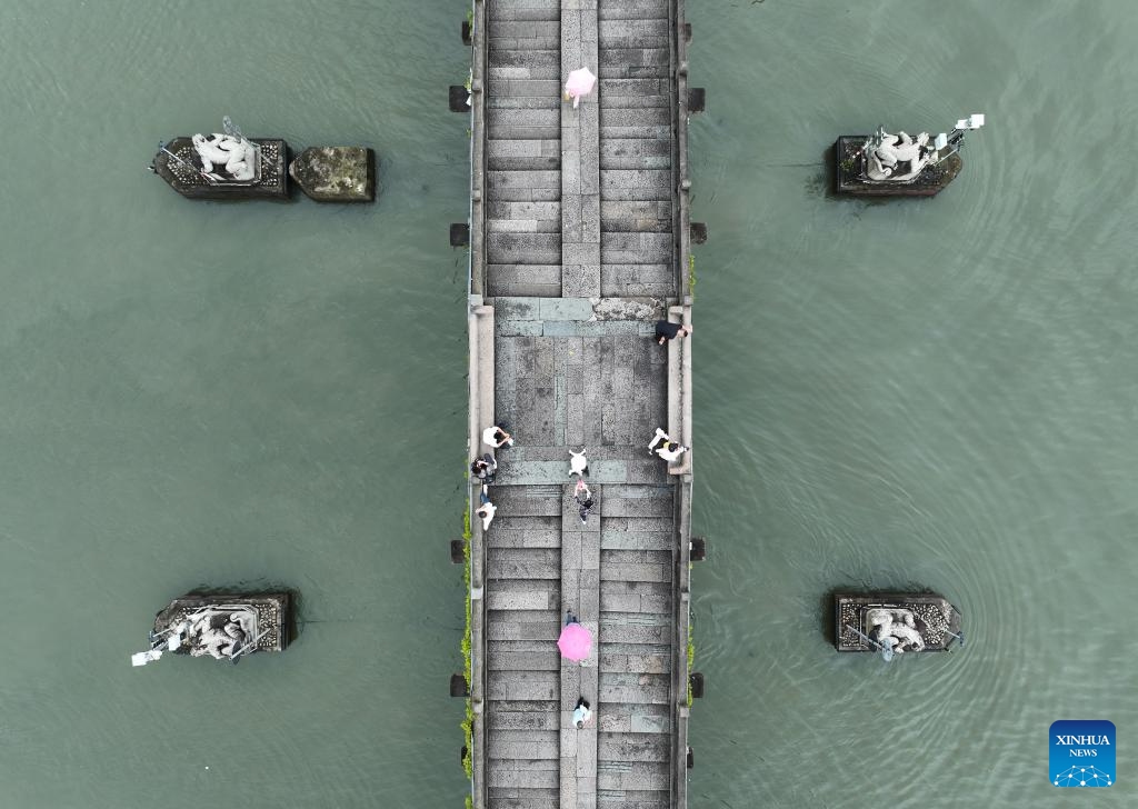 An aerial drone photo taken on June 12, 2024 shows the Gongchen Bridge over the Grand Canal in Hangzhou, east China's Zhejiang Province. With a history of more than 2,500 years, the Grand Canal, connecting Beijing and Hangzhou in east China's Zhejiang Province, served as a significant transportation artery in ancient China. The canal was listed as a UNESCO World Heritage Site in China in June 2014.(Photo: Xinhua)