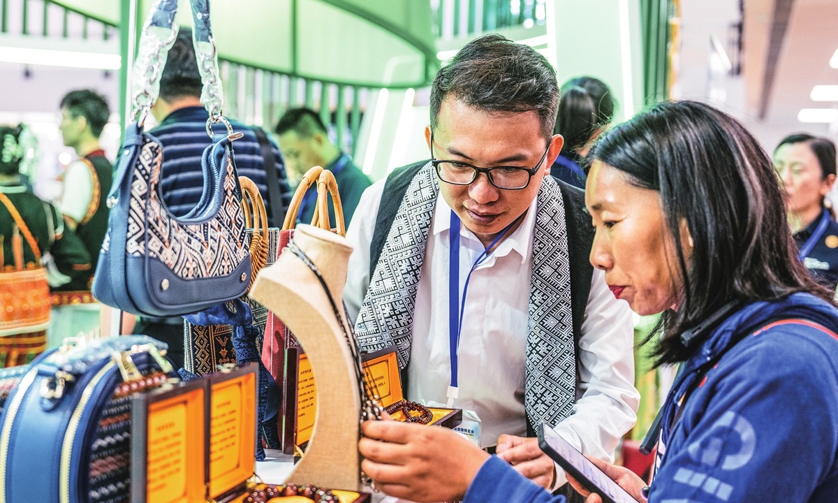 Visitors check out products at the 2024 Beijing International Tourism Expo, which kicked off in Beijing on June 14, 2024. There are more than 1,000 booths at the expo, attracting vendors from countries such as Russia, Japan and Vietnam, underscoring the vast potential and attractiveness of China's tourism market. Photo: Li Hao/GT