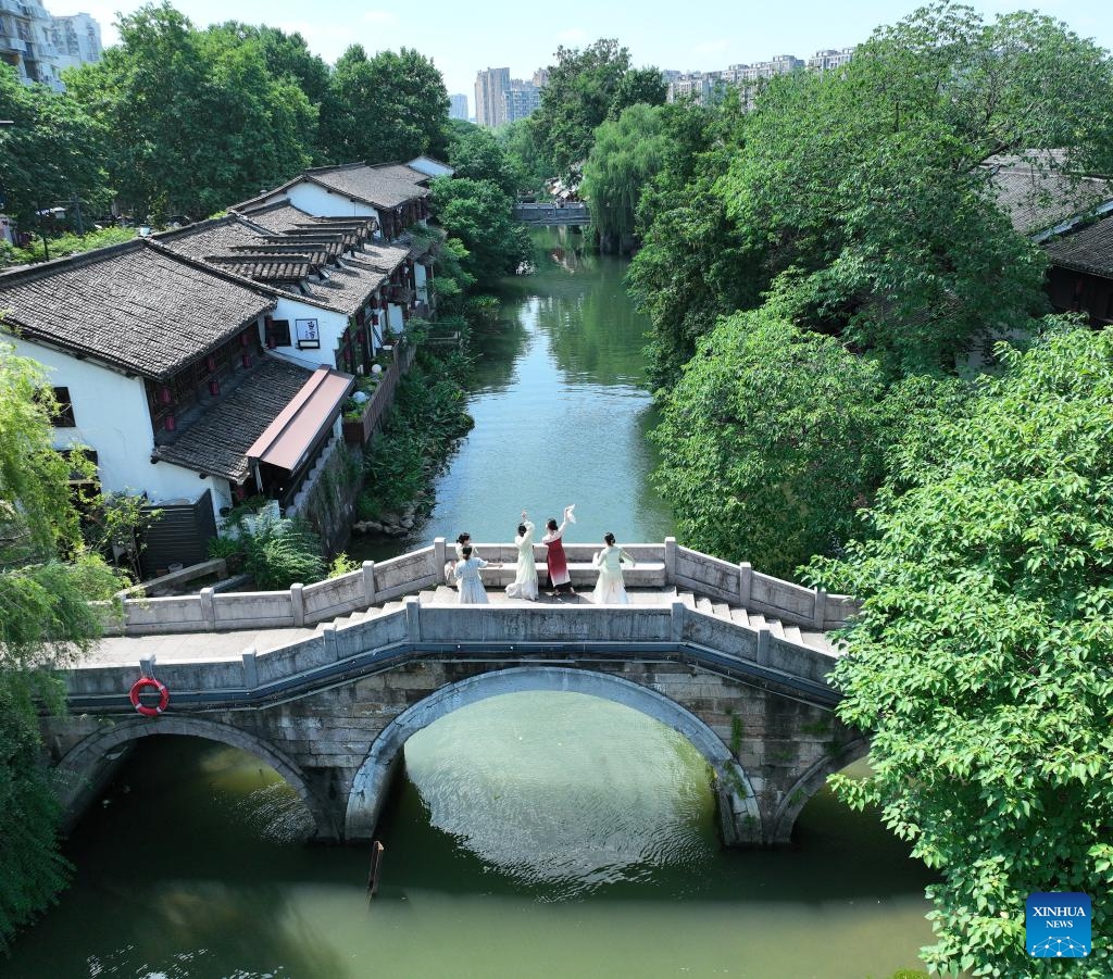An aerial drone photo taken on June 12, 2024 shows tourists visiting Xiaohezhi Street historical and cultural block along the Grand Canal in Hangzhou, east China's Zhejiang Province. With a history of more than 2,500 years, the Grand Canal, connecting Beijing and Hangzhou in east China's Zhejiang Province, served as a significant transportation artery in ancient China. The canal was listed as a UNESCO World Heritage Site in China in June 2014.(Photo: Xinhua)