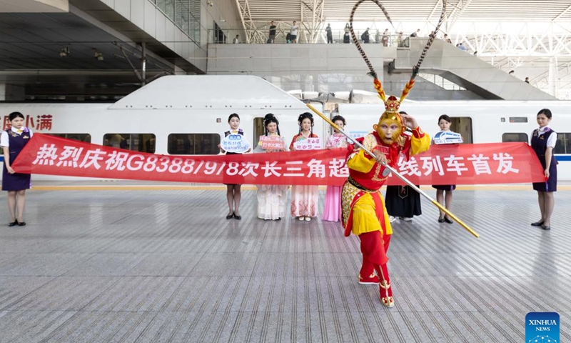 A dancer in the costume of Monkey King performs for passengers of the train G8388 at Shanghai Railway Station in east China's Shanghai, June 15, 2024.