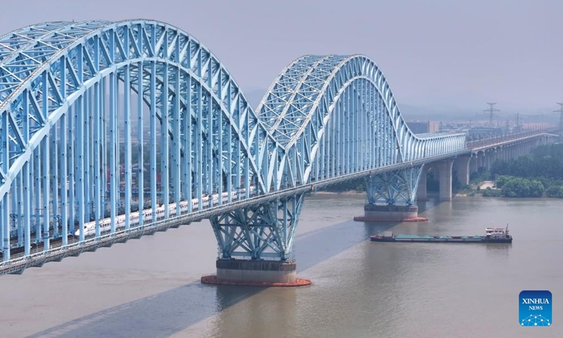 The train G8388 passes through the Dashengguan Yangtze River Bridge in Nanjing, east China's Jiangsu Province, June 15, 2024.