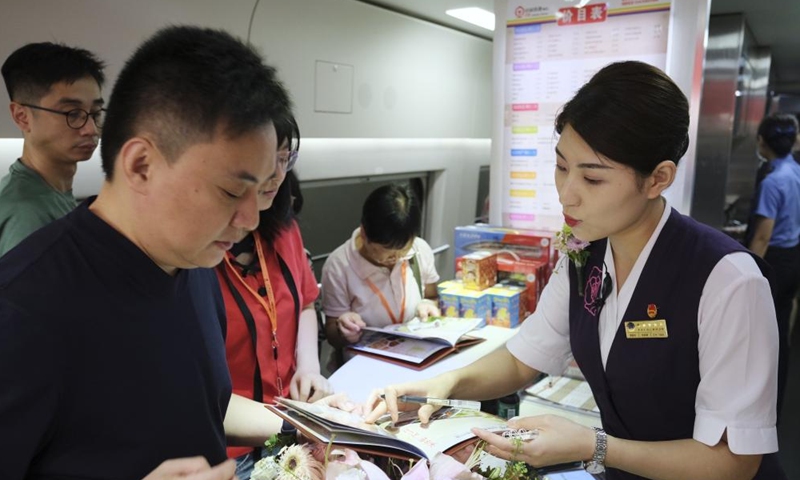 Passengers order food onboard the high-speed sleeper train D910 bound for Beijing West Railway Station, in Hong Kong, south China, June 15, 2024. (Photo: Xinhua)