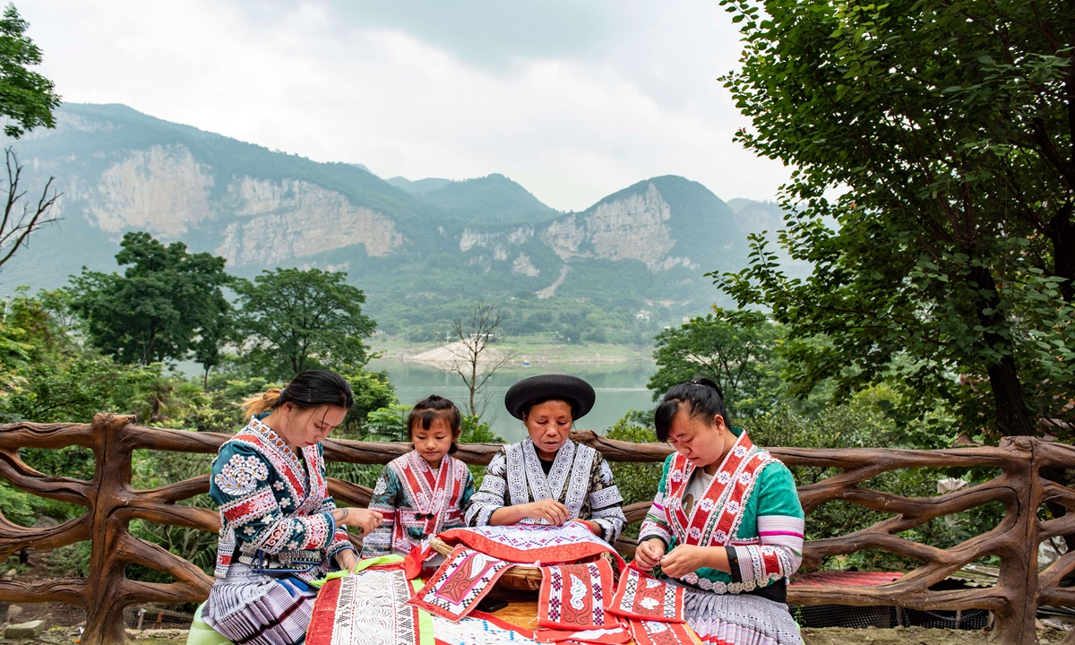 Local villagers produce embroidery in Bijie, Southwest China's Guizhou Province on June 16, 2024. The village, where a majority of residents are from Miao ethnic groups, has become a travel hotspot as village tourism booms. Miao embroidery has also gained popularity, which not only preserves local culture but also raises villagers' incomes. Photo: VCG