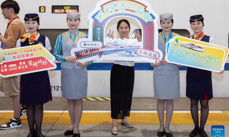 A passenger poses for photos before boarding the high-speed sleeper train D907 bound for Hong Kong's West Kowloon Station at Shanghai Hongqiao Railway Station in east China's Shanghai, June 15, 2024. (Photo: Xinhua)