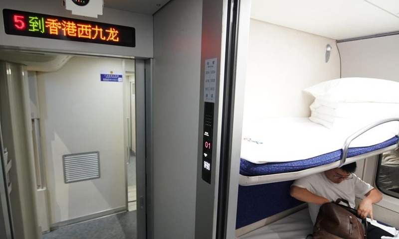 A passenger boards the high-speed sleeper train D909 bound for Hong Kong's West Kowloon Station at Beijing West Railway Station in Beijing, capital of China, June 15, 2024. (Photo: Xinhua)