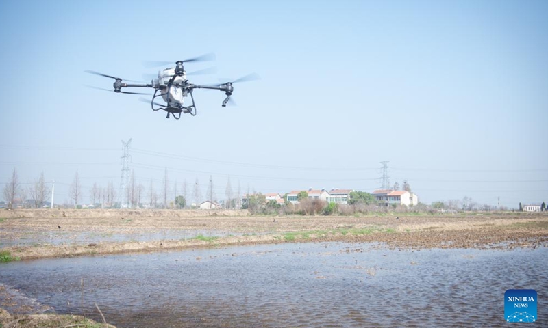 A drone sows seeds at a field in Hugangwan Village of Wuhan, central China's Hubei Province, March 15, 2023. With the application of technologies such as 5G and BeiDou Navigation Satellite System, the intelligent level of traditional industries in China's central region has been upgraded in recent years. (Photo: Xinhua)