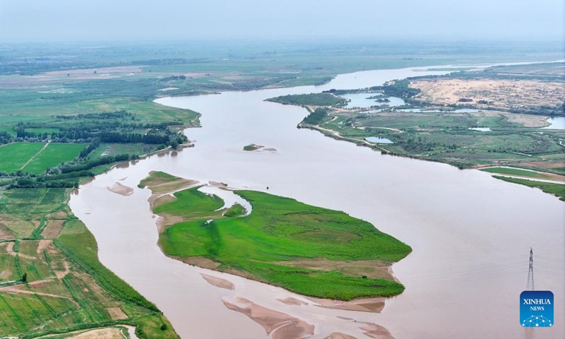 An aerial drone photo taken on June 13, 2024 shows a section of the Yellow River in northwest China's Ningxia Hui Autonomous Region. The Yellow River, China's second-largest river after the Yangtze, is dubbed the mother river. In recent years, continued efforts have been made to protect its ecology, as vitality has returned to the Yellow River basin in Ningxia. (Photo: Xinhua)