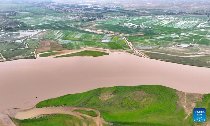 An aerial drone photo taken on June 13, 2024 shows a section of the Yellow River in northwest China's Ningxia Hui Autonomous Region. The Yellow River, China's second-largest river after the Yangtze, is dubbed the mother river. In recent years, continued efforts have been made to protect its ecology, as vitality has returned to the Yellow River basin in Ningxia. (Photo: Xinhua)