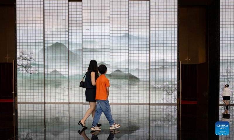 People pass a multimedia art installation at the Grand Halls in Shanghai, east China, June 16, 2024. The first public open day of the Grand Halls was launched in Shanghai on Sunday, attracting many visitors. Consisting of three old buildings with an area of 99,000 square meters, the Grand Halls previously was the Yangtze River wharf with a history of more than 100 years. (Photo: Xinhua)