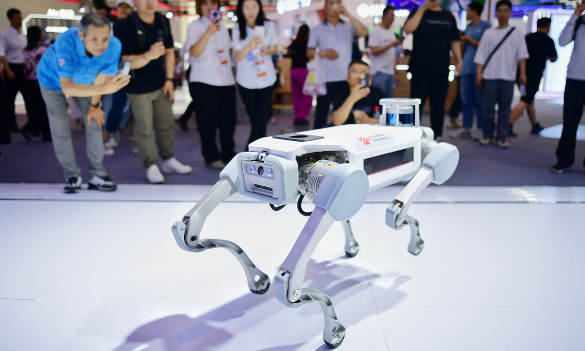 Visitors take photos of a robot dog at the World Intelligence Expo 2024 in North China's Tianjin Municipality on June 20, 2024. The revenue of Tianjin's artificial intelligence industry exceeded 300 billion yuan ($41.32 billion) in 2023, according to the Xinhua News Agency. Photo:cnsphoto