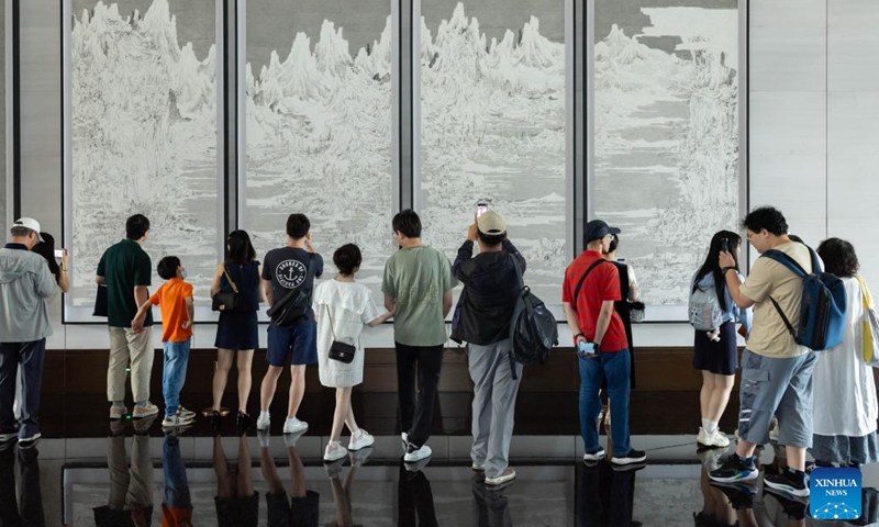 People watch art pieces at the Grand Halls in Shanghai, east China, June 16, 2024. The first public open day of the Grand Halls was launched in Shanghai on Sunday, attracting many visitors. Consisting of three old buildings with an area of 99,000 square meters, the Grand Halls previously was the Yangtze River wharf with a history of more than 100 years. (Photo: Xinhua)