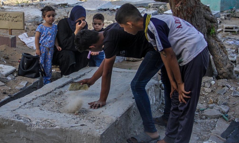 Palestinians visit a cemetery where their relatives are buried in Jabalia refugee camp in the northern Gaza Strip on the first day of Eid al-Adha, on June 16, 2024. (Photo: Xinhua)